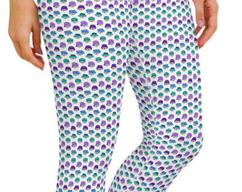 May include: White cropped leggings with a repeating pattern of small, cartoon-like faces wearing hats in teal, purple, and blue. The leggings are made of a stretchy material and are suitable for athletic activities.