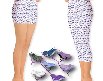 May include: Two pairs of leggings with a white background and a repeating pattern of purple, blue, and gray birds. The leggings are shown on two models, one wearing shorts and the other wearing capris. The image also includes a graphic of six birds of different colors perched on a branch.