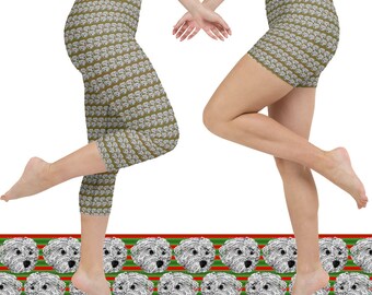 May include: Cropped leggings and shorts featuring a repeating pattern of white dog faces on a khaki background. The leggings and shorts are displayed on a white background with a decorative border of dog faces and red and green stripes.