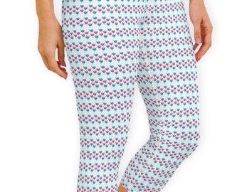 May include: White capri leggings with a repeating pattern of small blue and pink bird-like shapes. The leggings are cropped at the calf and appear to be made of a stretchy material.