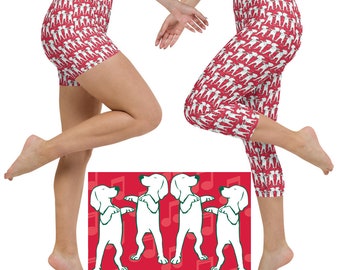 May include: Red athletic shorts and capri leggings with a repeating white dog pattern. A red rectangle at the bottom features four white dogs in a dancing pose, with musical notes in the background.