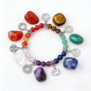 May include: A chakra bracelet with a rainbow of beads and silver charms, surrounded by seven polished gemstones in corresponding colours. The bracelet features red, orange, yellow, green, blue, indigo, and violet beads, and is a spiritual accessory.