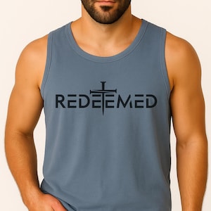 Searching for a meaningful yet stylish gift? Our Comfort Colors tank featuring the bold “Redeemed” design is the perfect choice. This faith-inspired shirt isn’t just another tee—it’s a powerful expression of Christian beliefs and personal testimony. Whether you're shopping for a thoughtful birthday gift, encouragement for a loved one, or simply want to bless someone with a message of redemption, this shirt makes a lasting impression.