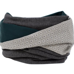 May include: A gray, teal, and white patterned infinity scarf. The scarf is made of a soft, comfortable fabric and is perfect for keeping warm in the winter.