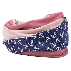 May include: A pink and navy blue infinity scarf with a white anchor print.