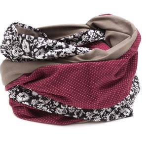 May include: A multi-colored fabric neck warmer with a floral pattern and polka dots. The neck warmer is made of soft, comfortable fabric and is perfect for keeping warm in the winter.