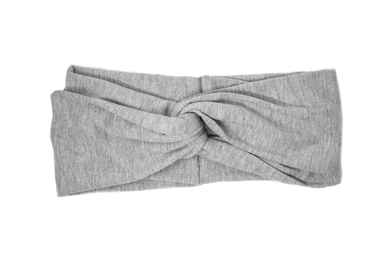 May include: A gray knotted headband made of soft fabric.