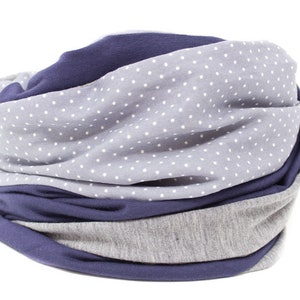 May include: A gray and navy blue infinity scarf with a white polka dot pattern.