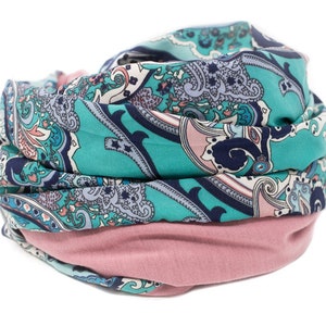 May include: A turquoise and pink paisley patterned scarf with a folded design.