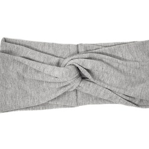 May include: A gray knotted headband made of soft fabric.