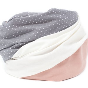 May include: A gray and white polka dot fabric scarf with a pink fabric section.