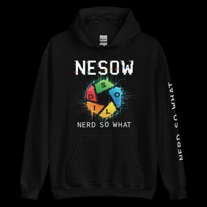 May include: Black hoodie with the text "NESOW" above a colourful graphic and "NERD SO WHAT" below. The sleeve features the text "NERD SO WHAT" in white.