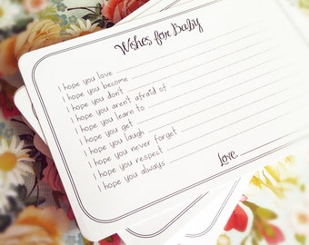 Pode incluir: Um conjunto de cartões brancos com bordas e linhas pretas. Os cartões têm o texto "Wishes for Baby" no topo e uma lista de desejos para um bebê, como "Espero que você ame", "Espero que você se torne", "Espero que você não faça", "Espero que você não tenha medo de", "Espero que você aprenda a", "Espero que você consiga", "Espero que você ria", "Espero que você nunca esqueça", "Espero que você respeite", e "Espero que você sempre". Os cartões também têm um espaço para uma assinatura e a palavra "Love" escrita abaixo da lista de desejos.