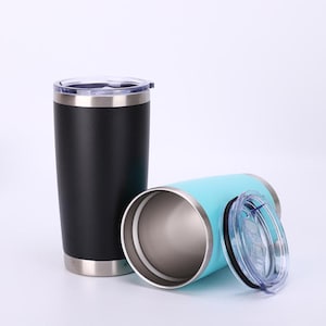 May include: Two stainless steel insulated tumblers. One is black, upright, with a clear lid. The other is light blue, lying on its side, with a clear lid off to the side. Both tumblers have a silver rim at the top and bottom.