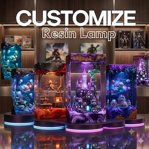 May include: A collection of rectangular resin lamps featuring internal dioramas including a deep-sea scene with an anglerfish, a mechanical spider, a purple castle with a green dragon, and a space scene with planets. Text reads CUSTOMIZE Resin Lamp.