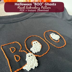 May include: A black t-shirt featuring hand embroidery of the word BOO in orange thread. The letters O are circular, containing small white embroidered ghosts with black eyes. The text Halloween BOO Ghosts Hand Embroidery Pattern PDF is visible.
