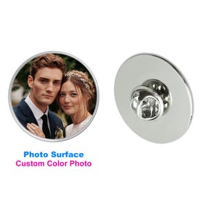 May include: A round, silver-colored lapel pin with a photo surface. The photo surface features a color image of a couple. The text "Photo Surface Custom Color Photo" is displayed in blue and pink.