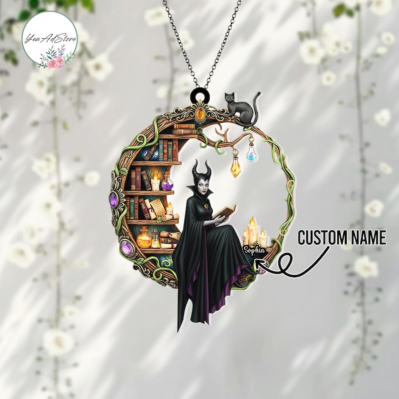 May include: A black Maleficent-themed pendant necklace. The pendant features Maleficent reading a book, a black cat, a bookshelf, and candles. The pendant is surrounded by a crescent-shaped frame with vines and gemstones. The text "CUSTOM NAME" is also visible.