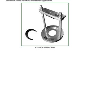 May include: A silver-colored magnetic reference holder with a circular base and a rectangular top. The holder has two vertical supports and is designed to hold black and white references. The text "PC21179-UN: Reference Holder" is visible.