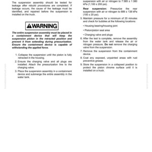 May include: A page from a manual detailing a suspension pressure test. The text includes instructions for testing, warnings, and steps for pressurizing and inspecting the suspension system. The page also includes a warning about the containment device.