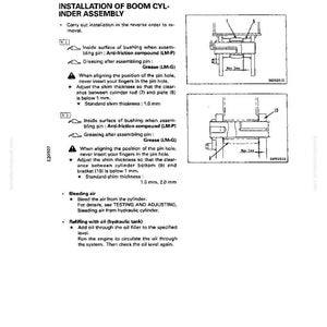 May include: A technical diagram from a manual detailing the installation of a boom cylinder assembly. The page includes diagrams, instructions, and specifications for the assembly process, including measurements in millimeters.