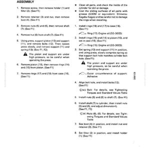 May include: A page from a manual detailing the disassembly and assembly of a parking brake spring cylinder. The text is in black font on a white background, with diagrams and numbered steps.
