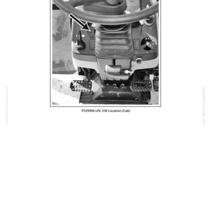 May include: Black and white image of a tractor cab interior. The steering wheel is at the top, with controls and levers below. The text "PY29996-UN: S36 Location (Cab)" is at the bottom.