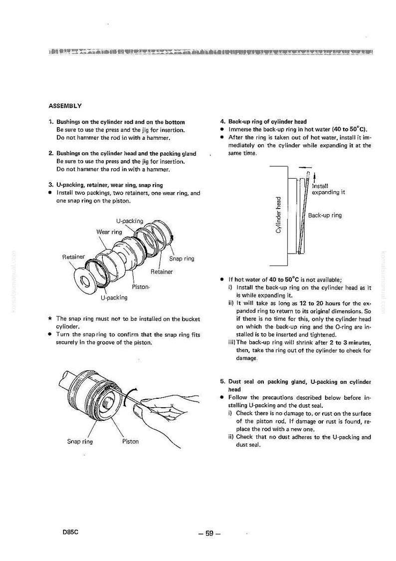 May include: Diagram of an assembly process with labeled parts: U-packing, retainer, wear ring, and snap ring. Instructions detail installing parts, including a back-up ring in hot water. Text includes "ASSEMBLY" and "D85C - 59".