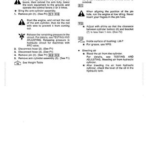 May include: A page from a manual detailing the removal and installation of an arm cylinder assembly. The text includes instructions, diagrams, and safety warnings. The page is white with black text and symbols.