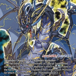 May include: A trading card titled Thunder Dragon Colossus featuring a dark blue and black dragon with yellow lightning bolts on its body, red eyes, and large wings. The card displays the text ATK 2600/DEF 2400 and detailed game rules.