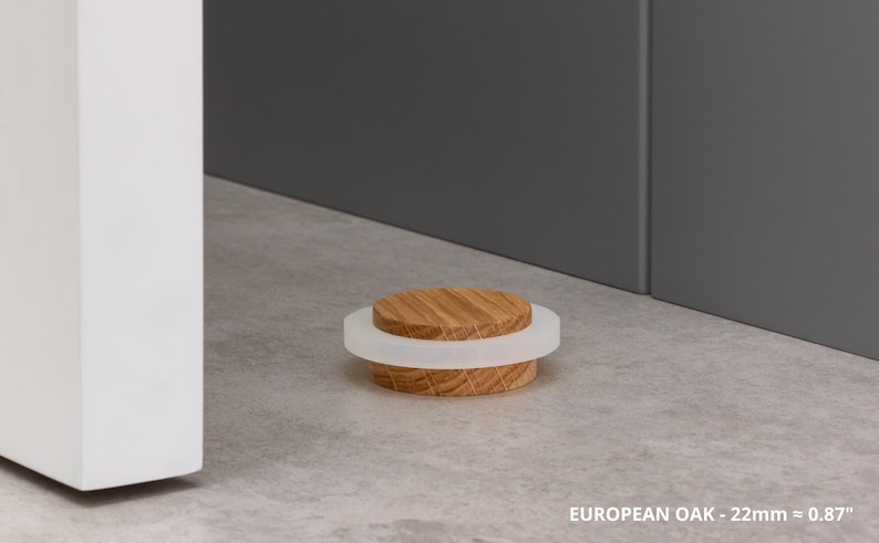 May include: A wooden bottle stopper with a light-colored, circular top and a white, translucent ring. The stopper is made of European oak and is approximately 0.87 inches in diameter. The image is set against a neutral background.
