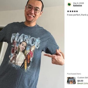 May include: A dark heather grey short-sleeve t-shirt featuring a graphic print with the word FIANC&Eacute; in a stylized silver font at the top. Below the text, there is a collage of multiple photographs of a person, accented with blue sparkles.