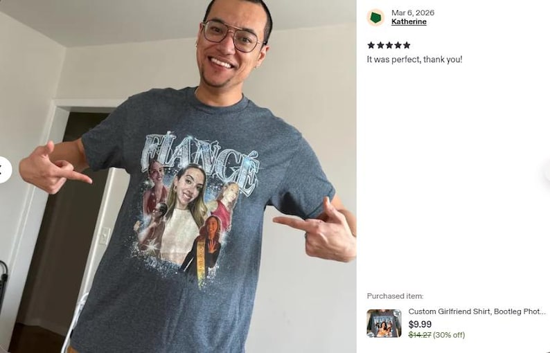 May include: A dark heather grey short-sleeve t-shirt featuring a graphic print with the word FIANC&Eacute; in a stylized silver font at the top. Below the text, there is a collage of multiple photographs of a person, accented with blue sparkles.