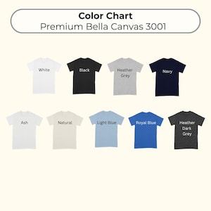 May include: A color chart for Premium Bella Canvas 3001 t-shirts displaying nine short-sleeve shirts in white, black, heather grey, navy, ash, natural, light blue, royal blue, and heather dark grey, each labeled with its respective color name.