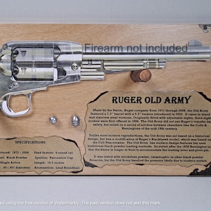 May include: A detailed display featuring a Ruger Old Army revolver, mounted on a wooden plaque. The firearm is silver and brown, with text indicating it's a replica. The plaque includes specifications and historical information. The length is 14.5 inches.