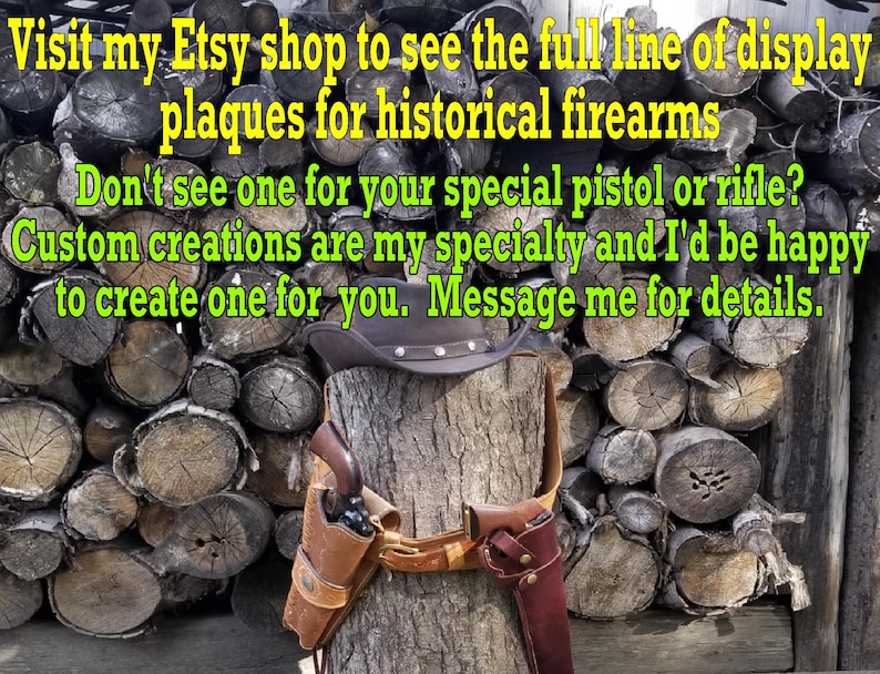 May include: A brown leather holster with a pistol and a matching holster for a rifle are displayed on a tree stump. A cowboy hat sits atop the stump, with text in the background.