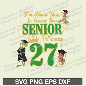 May include: A graphic design featuring the text I'm Almost There Senior Princess 27 in green and gold. The illustration includes a frog wearing a graduation cap and gown, and two figures in green dresses wearing graduation caps and gowns.