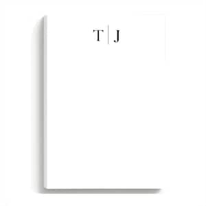 May include: A white notepad with the initials "T | J" printed in black. The notepad is rectangular and has a clean, minimalist design, perfect for jotting down notes or reminders.