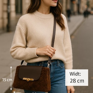 May include: A brown shoulder bag with a flap closure and gold-colored hardware. The bag has a fluffy, textured body and a smooth, dark brown flap. The bag is 11 inches wide and 6 inches high.