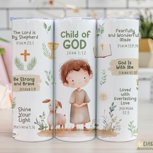 May include: A white tumbler with religious imagery and text. The design includes a child, a lamb, a cross, and Bible verses like "Child of God" and "The Lord is my Shepherd." The tumbler is decorated with floral accents and is suitable for hot or cold drinks.