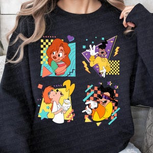 May include: A black sweatshirt with a colorful graphic print featuring four cartoon characters in a 90s style. The characters are Goofy, Max, Pete, and a dog.