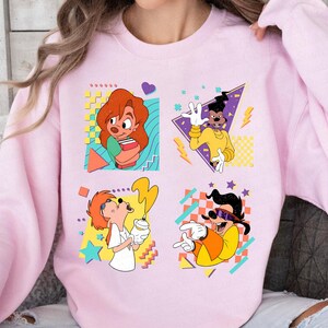May include: Pink sweatshirt with a retro 90s design featuring four cartoon characters from the Disney movie A Goofy Movie. The characters are Goofy, Max Goofy, Pete, and Powerline. The sweatshirt has a colorful geometric pattern.