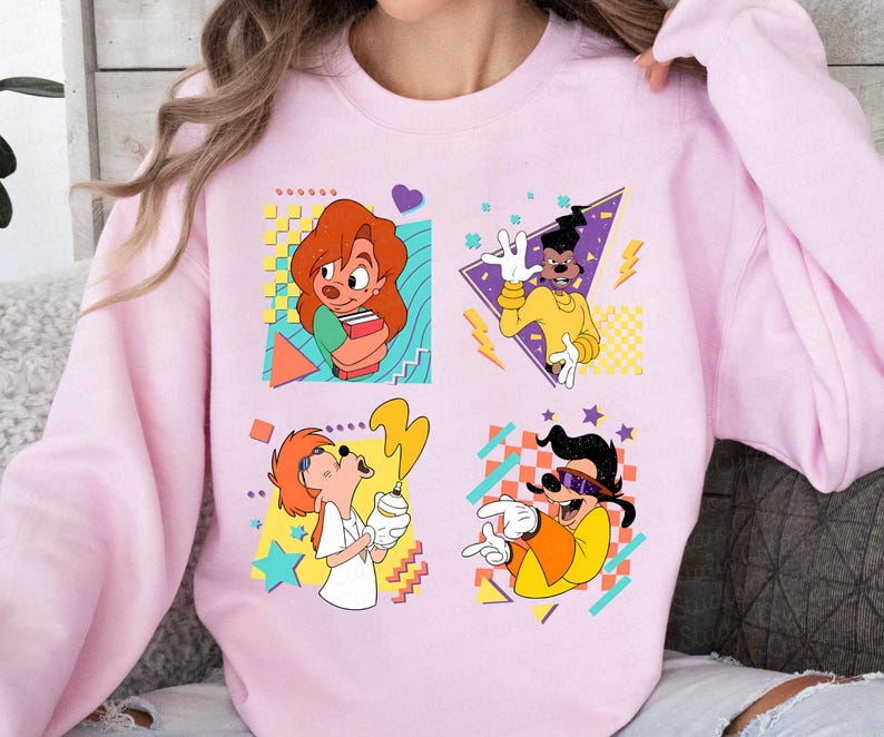 May include: Pink sweatshirt with a retro 90s design featuring four cartoon characters from the Disney movie A Goofy Movie. The characters are Goofy, Max Goofy, Pete, and Powerline. The sweatshirt has a colorful geometric pattern.