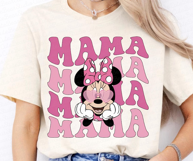 May include: A white t-shirt with a pink graphic of Mickey Mouse wearing heart-shaped sunglasses and the text "MAMA" repeated four times.