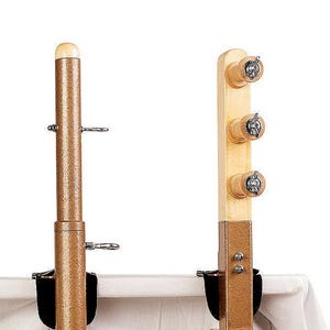 May include: Two wooden table clamp yarn holders. The holder on the left has a single post with a knob on top. The holder on the right has three posts with knobs on top. Both holders have a clamp that attaches to the table.