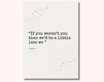 May include: A white rectangular print with the quote "If you weren't you then we'd be a little less we" attributed to Piglet. The print has a speckled texture and star-like designs in the corners.