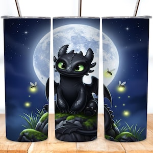 May include: A stainless steel tumbler featuring a black dragon with green eyes, perched on a mossy rock under a full moon. The design includes fireflies and a starry night sky, creating a whimsical scene.