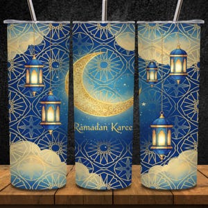 May include: A stainless steel tumbler with a Ramadan Kareem design. The tumbler features a blue background with gold geometric patterns, a crescent moon, lanterns, and the text "Ramadan Kareem". The design is repeated around the tumbler.