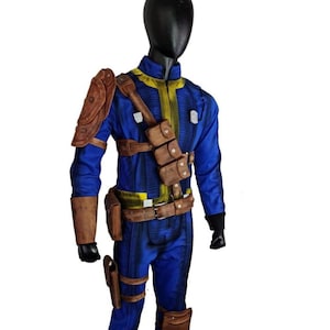 May include: A blue jumpsuit with yellow accents, brown leather pouches, and shoulder armor. The costume is displayed on a mannequin. The outfit includes a belt, holsters, and knee pads, creating a complete ensemble.