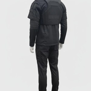 May include: Black tactical uniform set, including a long-sleeved shirt, cargo pants, and a vest with shoulder and chest padding. The uniform is displayed on a mannequin against a white background.